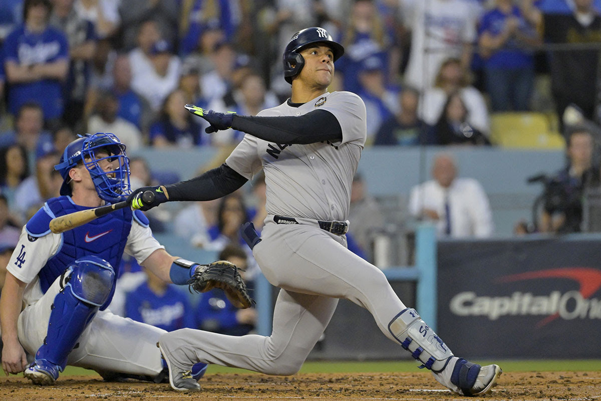 New York Yankees outfielder Juan Soto (22) hits a solo home run in the third inning against the Los Angeles Dodgers during game two of the 2024 MLB World Series at Dodger Stadium.