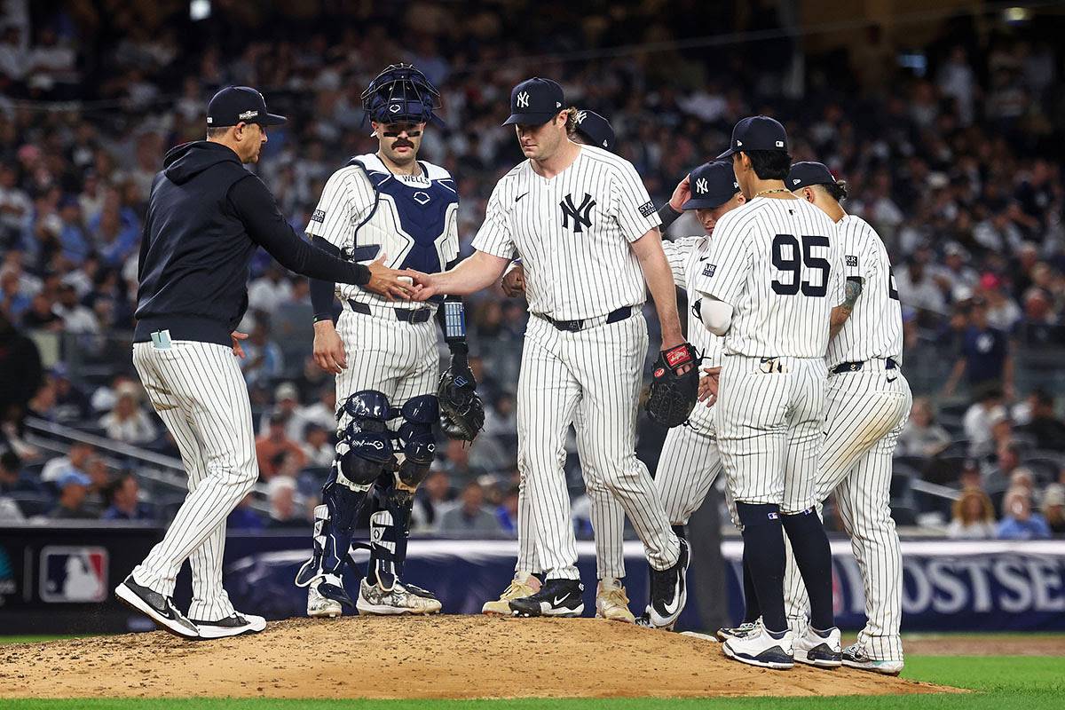 New York Yankees manager Aaron Boone (17) relieves New York Yankees pitcher Gerrit Cole (45) during the sixth inning against the Kansas City Royals during game one of the ALDS for the 2024 MLB Playoffs at Yankee Stadium.