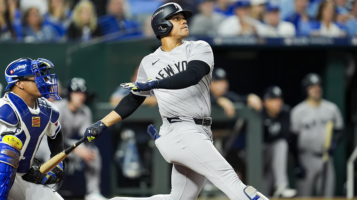 New York Yankees outfielder Juan Soto (22) hits a sacrifice fly during the fifth inning against the Kansas City Royals in game three of the ALDS for the 2024 MLB Playoffs at Kauffman Stadium.