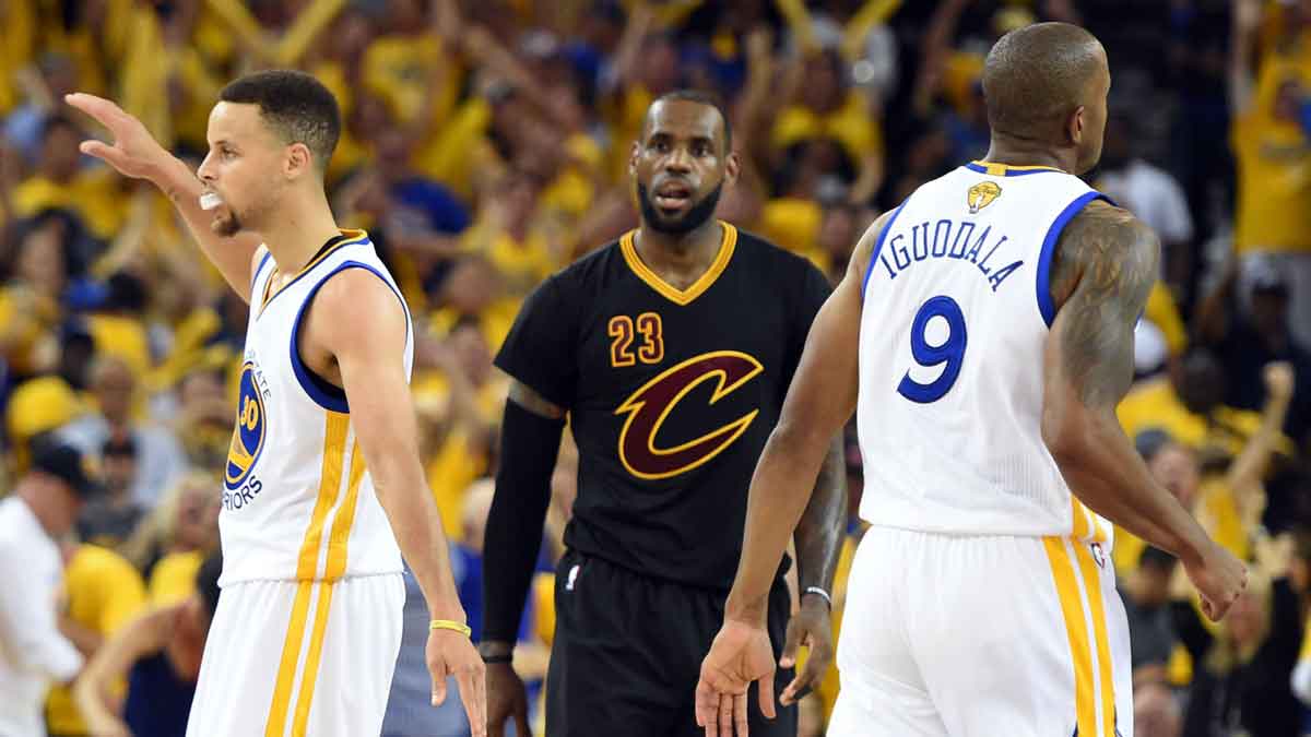 Jun 19, 2016; Oakland, CA, USA; Golden State Warriors guard Stephen Curry (30) celebrates with forward Andre Iguodala (9) in front of Cleveland Cavaliers forward LeBron James (23) during the third quarter in game seven of the NBA Finals at Oracle Arena. The Cavaliers pulled off the greatest comeback in NBA Finals history, winning the 2016 NBA championship after trailing 3-1.