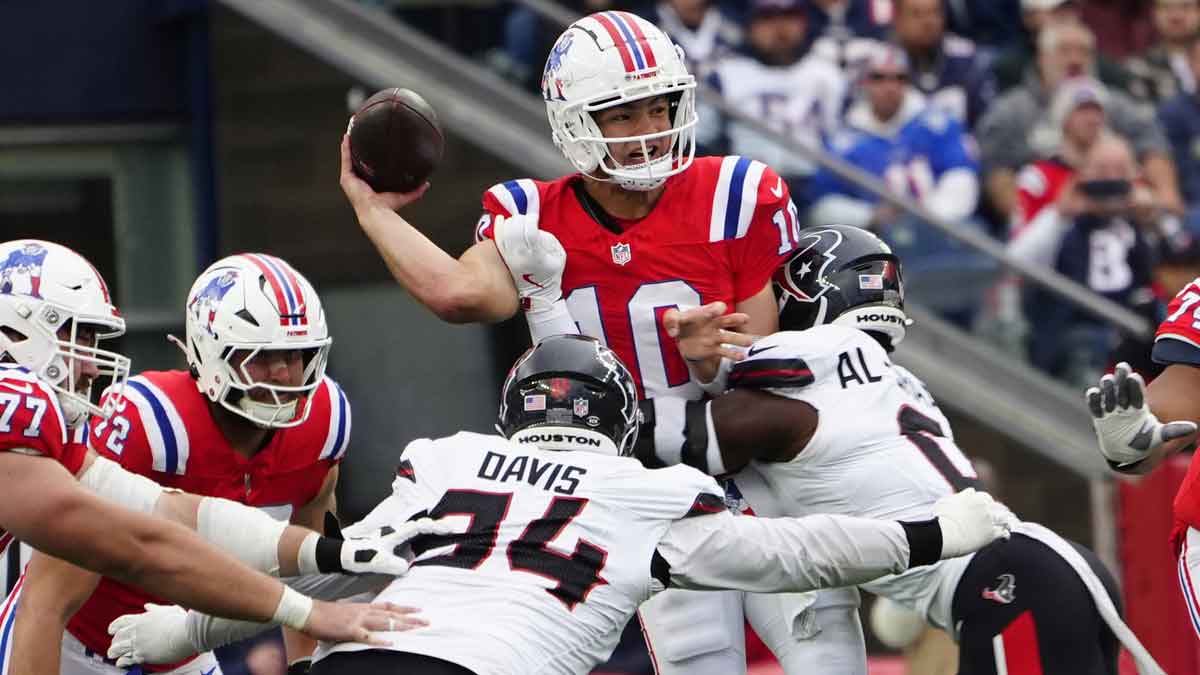 Houston Texans linebacker Azeez Al-Shaair (0) and Houston Texans defensive tackle Khalil Davis (94) pressure New England Patriots quarterback Drake Maye (10) as he makes a throw during the first half at Gillette Stadium