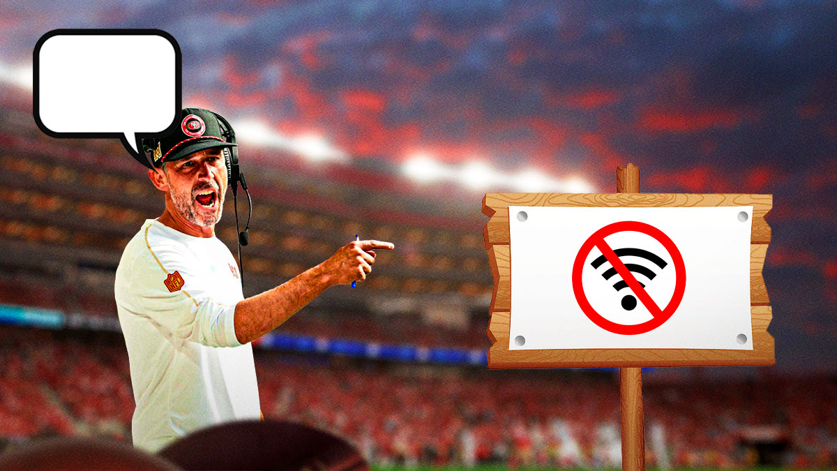 San Francischo 49ers head coach Kyle Shanahan with an empty speech bubble above his head standing in front of Levi's Stadium pointing to a sign with no internet logo on it.