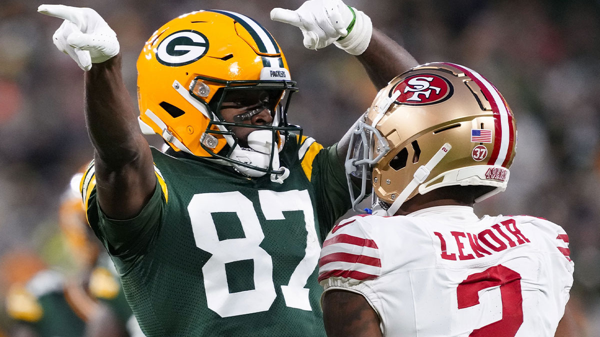 Green Bay Packers wide receiver Romeo Doubs (87) celebrates in front of San Francisco 49ers cornerback Deommodore Lenoir (2) after earning a first down during the second quarter at Lambeau Field.