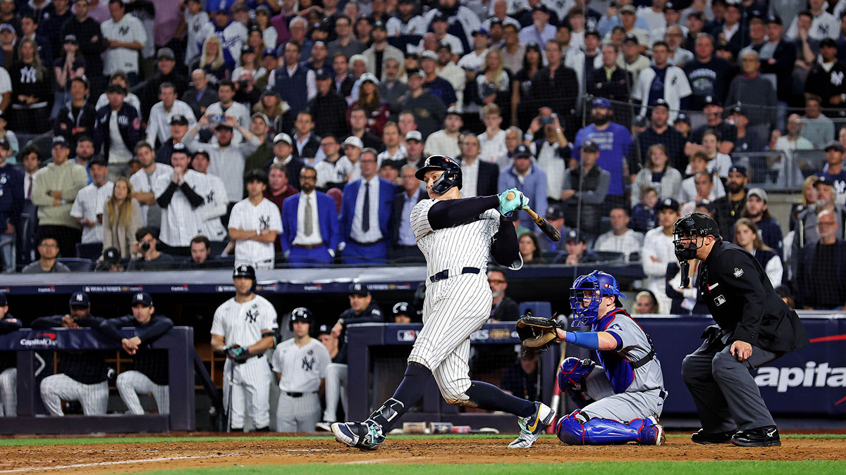 New York Yankees outfielder Aaron Judge (99) hits a double during the eighth inning against the Los Angeles Dodgers in game four of the 2024 MLB World Series at Yankee Stadium. 