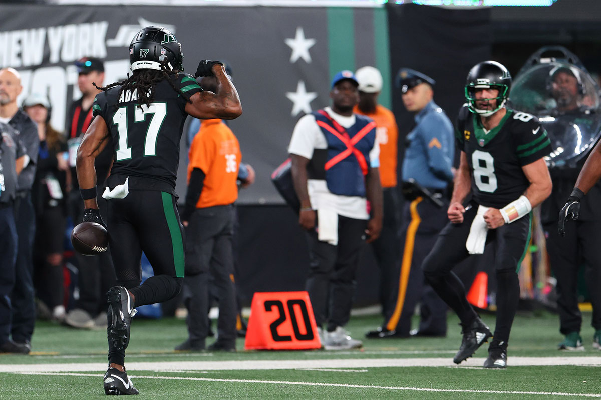 New York Jets wide receiver Davante Adams (17) and New York Jets quarterback Aaron Rodgers (8) celebrate a touchdown against the Houston Texans during the second half at MetLife Stadium.