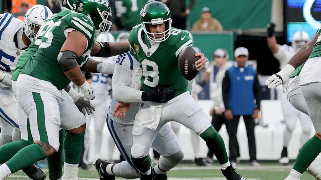 New York Jets quarterback Aaron Rodgers (8) is sacked by Indianapolis Colts defensive end Kwity Paye (51) as time runs out during the fourth quarter at MetLife Stadium.