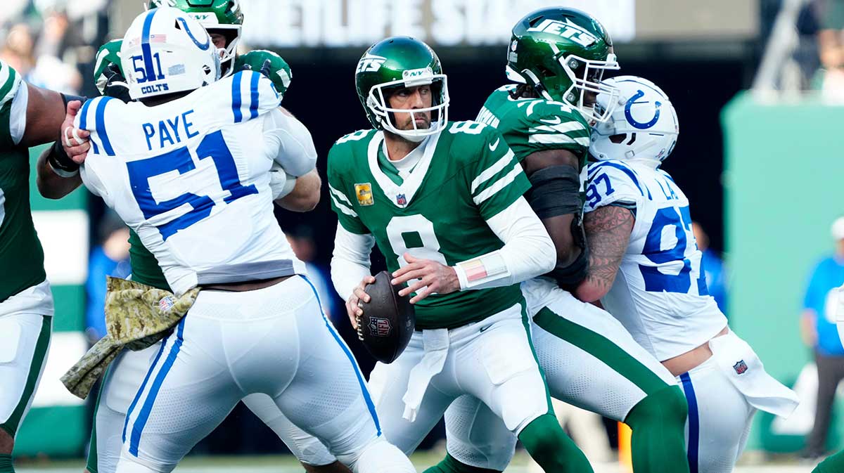 New York Jets quarterback Aaron Rodgers (8) looks for an open receiver as New York Jets offensive tackle Olu Fashanu (74) and other teammates try to protect him, Sunday, November 17, 2024, in East Rutherford.