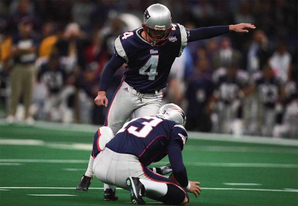 New England Patriots kicker Adam Vinatieri (4) kicks the ball against the St. Louis Rams during Super Bowl XXXVI at the Louisiana Superdome. The Patriots defeated the Rams 20-17.