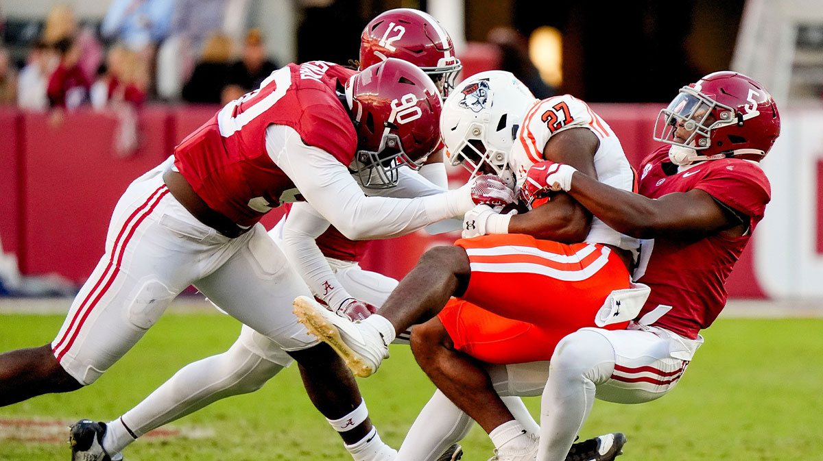 Alabama Crimson Tide defensive lineman Jordan Renaud (90),Alabama Crimson Tide defensive back Zavier Mincey (12) and Alabama Crimson Tide defensive back King Mack (5) combine to tackle Mercer running back Micah Bell (27) at Bryant-Denny Stadium. Alabama defeated Mercer 52-7