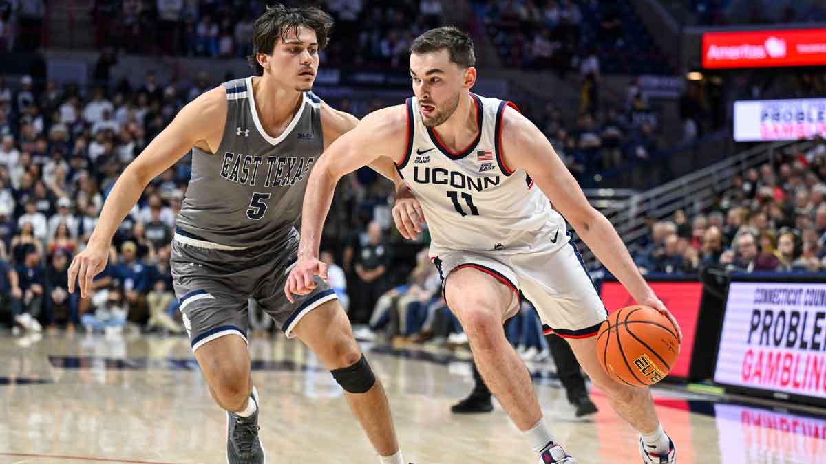 Connecticut Huskies forward Alex Karaban (11) dribbles the ball chased by Texas A&M Commerce guard Tay Mosher (5) during the second half at Harry A. Gampel Pavilion.