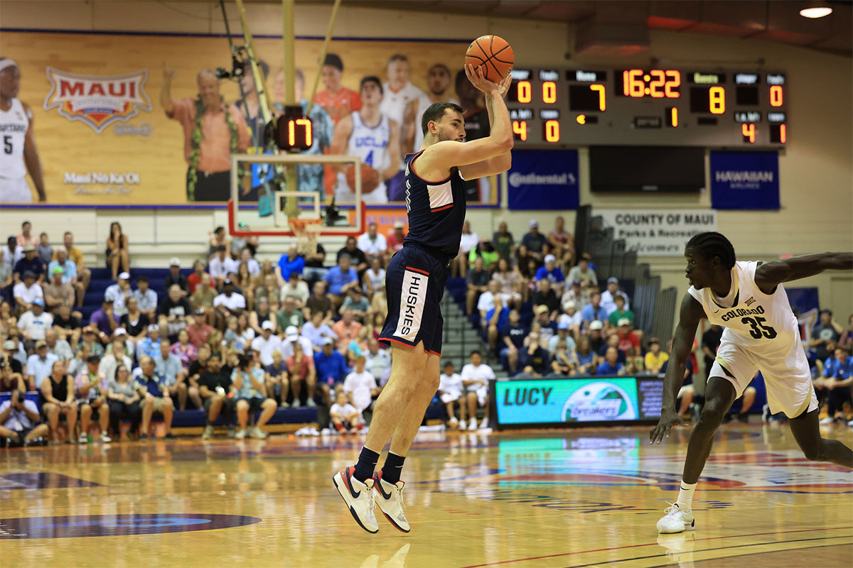 Connecticut Huskies forward Alex Karaban (11) takes a three point shot over Colorado Buffaloes forward Assane Diop (35) during the first half of an NCAA college basketball game at Lahaina Civic Center