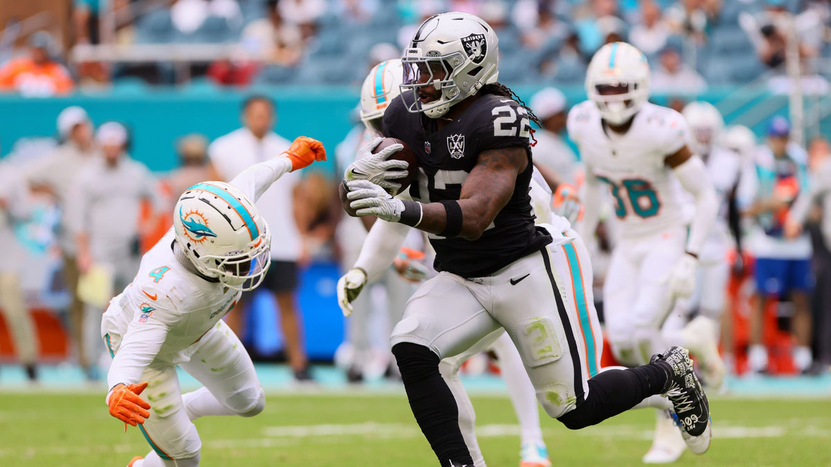 Las Vegas Raiders running back Alexander Mattison (22) runs with the football against Miami Dolphins cornerback Kader Kohou (4) during the fourth quarter at Hard Rock Stadium.