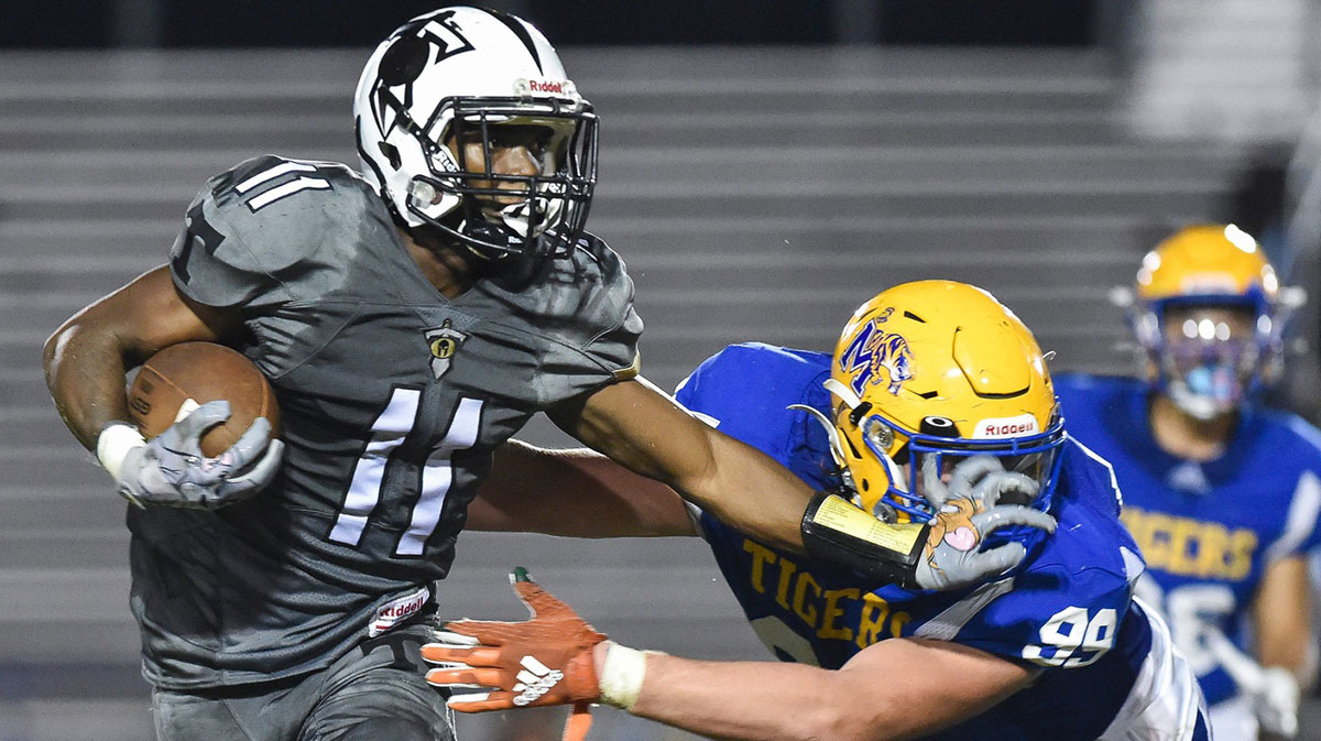 Treasure Coast's Jamison Davis (11) fends off Martin County's Alexander McPherson (99) in a Region 3-4S quarterfinal football game, Friday, Nov. 11, 2022, in Stuart. Treasure Coast won 35-7. Tcn Friday Football