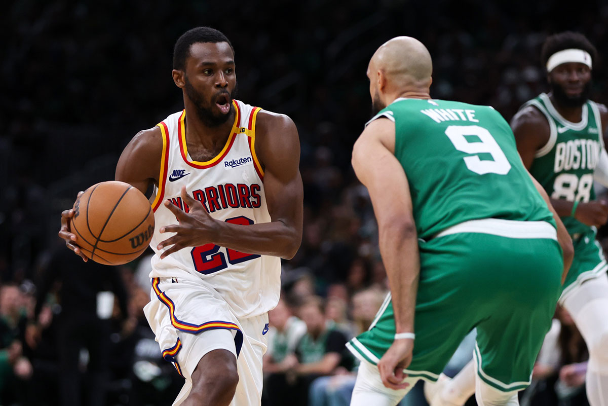 Gold State Warriors Next Andrew Wiggins (22) Drive to the basket defend Boston Celtics Guard Derrick White (9) during the second half in the TD garden.