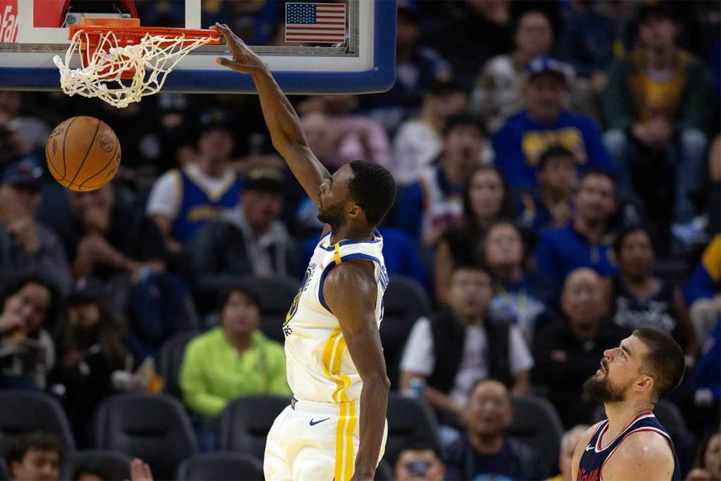 Golden State Warriors forward Andrew Wiggins (22) dunks ahead of Los Angeles Clippers center Ivica Zubac (40) during the third quarter at Chase Center.