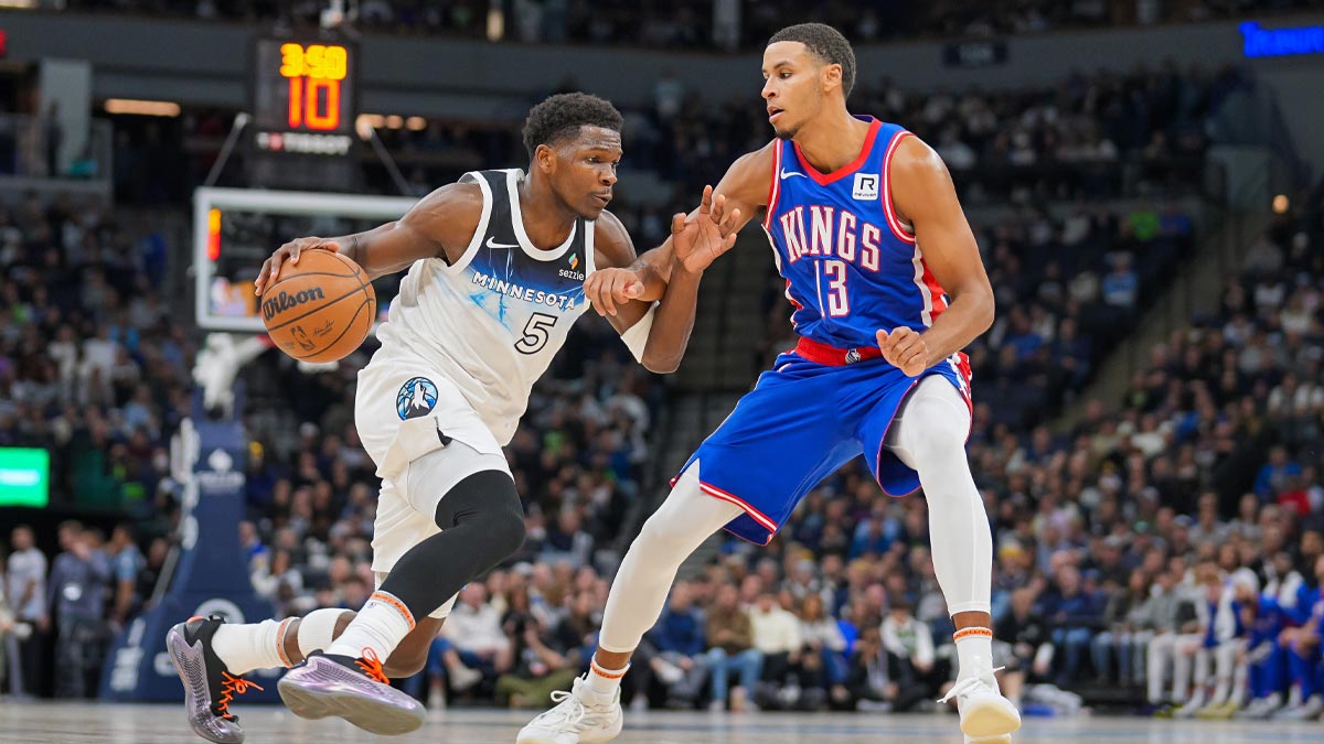 Minnesota Timberwolves guard Anthony Edwards (5) dribbles against the Sacramento Kings forward Keegan Murray (13) in the second quarter at Target Center. 