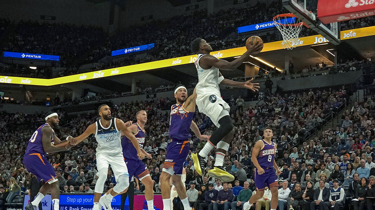 Minnesota Timberwolves guard Anthony Edwards (5) would get the basket and the foul on the play with Phoenix Suns guard Devin Booker (1) during the third quarter at Target Center. 