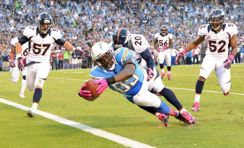 San Diego Chargers tight end Antonio Gates (85) is defended by Denver Broncos safety Mike Adams (20) and linebackers Wesley Woodyard (52) and Keith Brooking (57) on a 15-yard touchdown reception the first quarter at Qualcomm Stadium