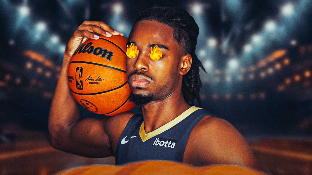 Pelicans Antonio Reeves with fire coming out of his eyes and the Smoothie King Center behind him