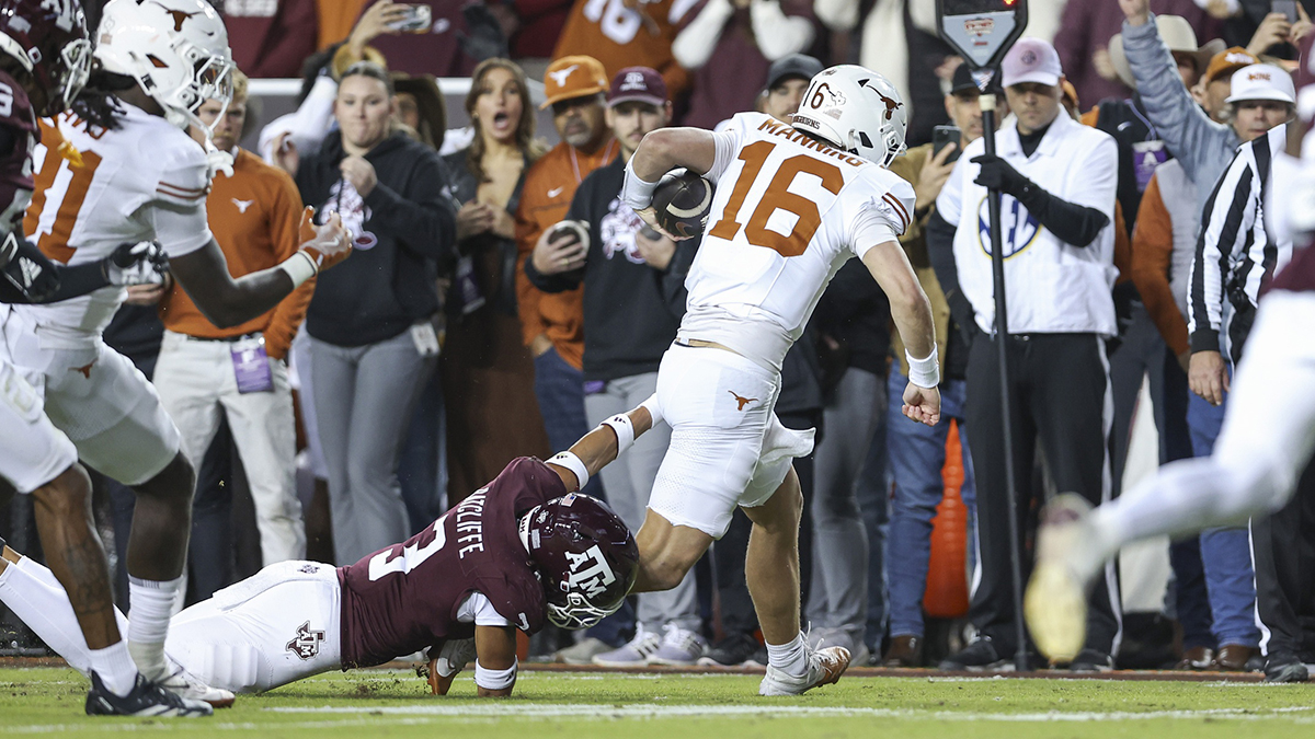 Texas Longhorns quarterback Arch Manning (16) runs with the football and scores a touchdown as Texas A&M Aggies defensive back Marcus Ratcliffe (3) defends during the first quarter at Kyle Field.