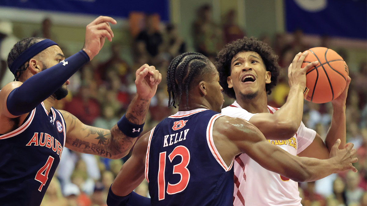Auburn Tigers forward Johni Broome (4) and guard Miles Kelly (13) guard Iowa State Cyclones guard Curtis Jones (5) during the first half an NCAA college basketball game at Lahaina Civic Center.