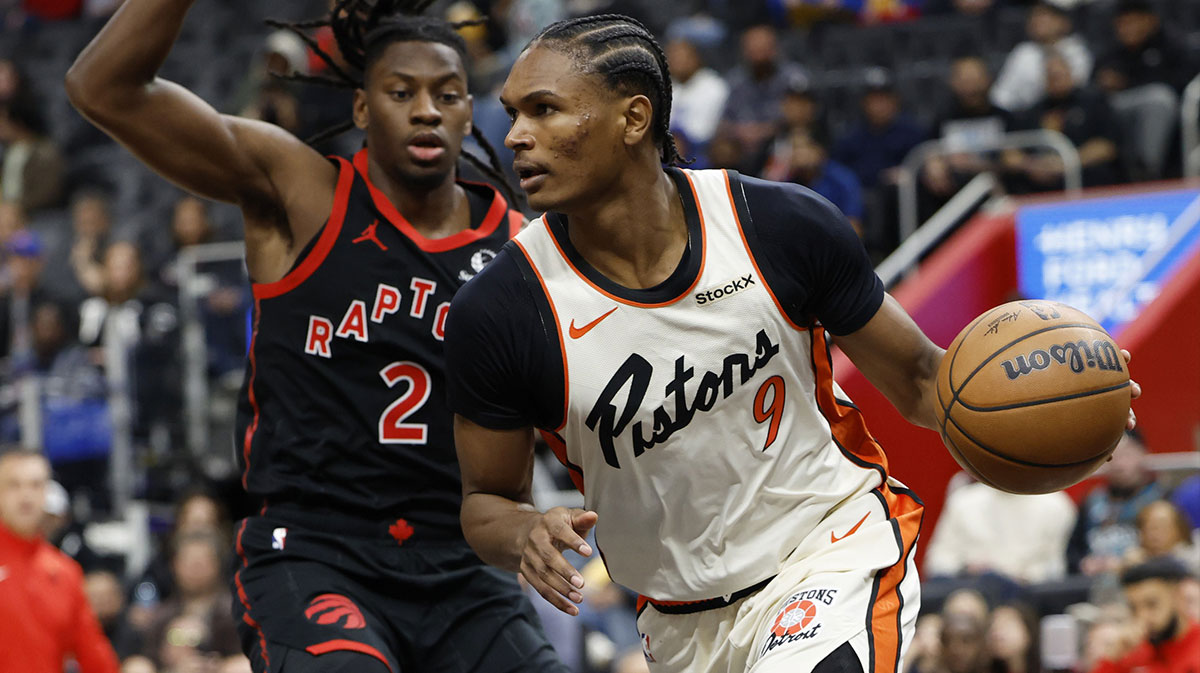 Detroit Pistons forward Ausar Thompson (9) dribbles defended by Toronto Raptors forward Jonathan Mogbo (2) in the first half at Little Caesars Arena.