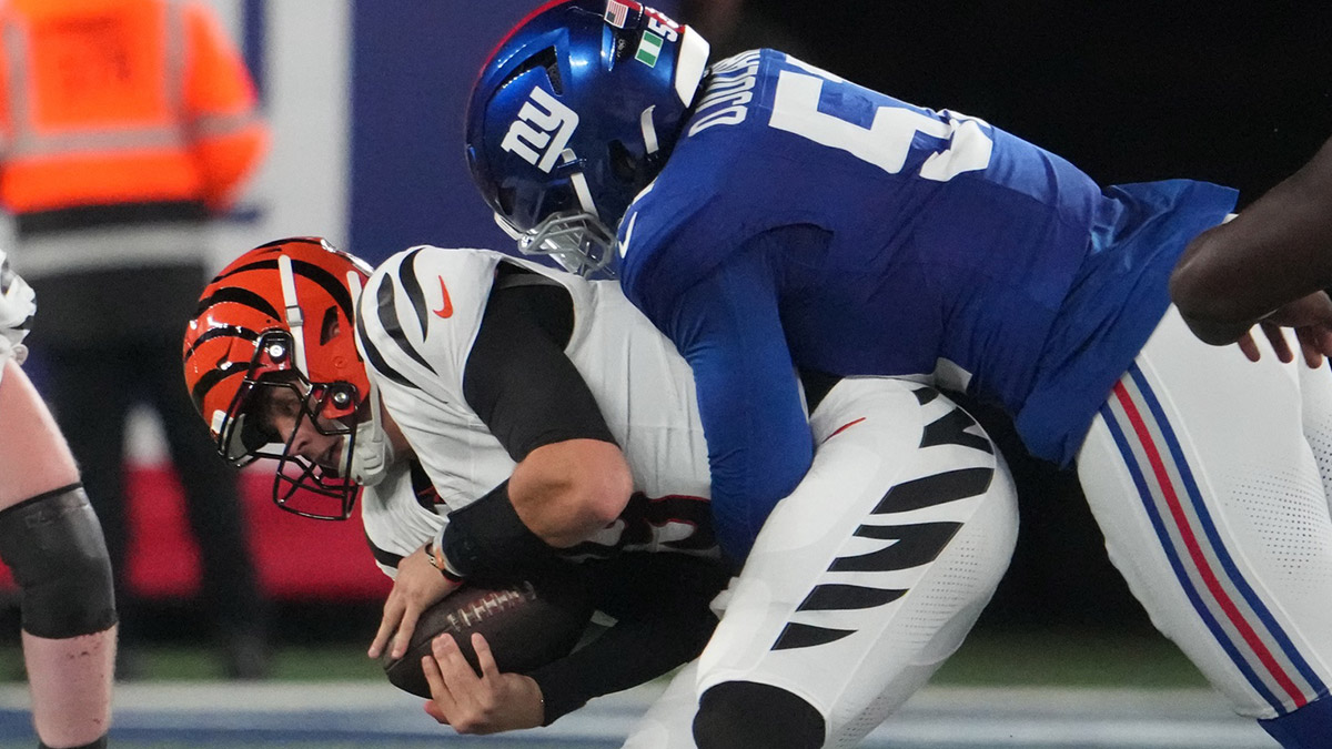 Oct 13, 2024; East Rutherford, New Jersey, USA; New York Giants linebacker Azeez Ojulari (51) tackles Cincinnati Bengals quarterback Joe Burrow (9) during the first half at MetLife Stadium.