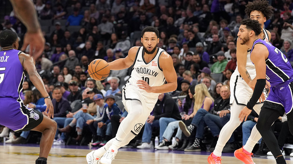 Brooklyn Nets guard Ben Simmons (10) dribbles against Sacramento Kings guards De'Aaron Fox (left) and Colby Jones (right) during the second quarter at Golden 1 Center.