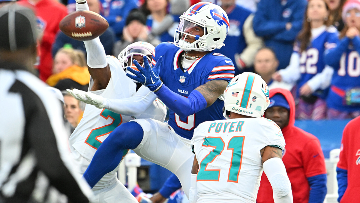 Buffalo Bills wide receiver Keon Coleman (0) tries to make a catch as Miami Dolphins safety Jordan Poyer (21) and cornerback Cam Smith (24) defend in the fourth quarter at Highmark Stadium