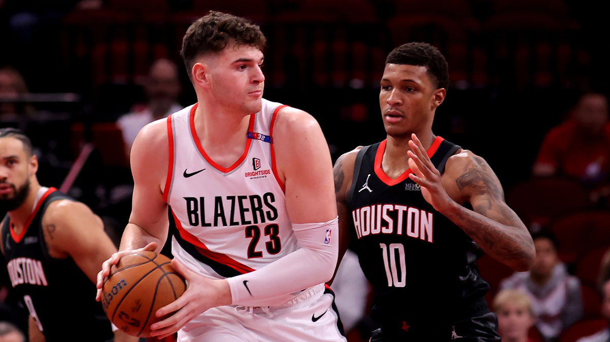 Portland Trail Blazers center Donovan Clingan (23) handles the ball against Houston Rockets forward Jabari Smith Jr (10) during the first quarter at Toyota Center