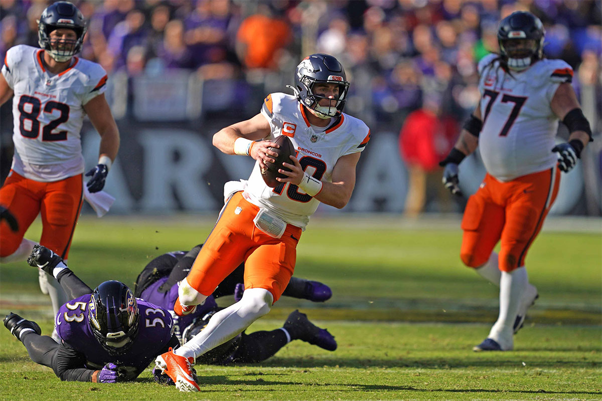 Denver Broncos quarterback Bo Nix (10) runs for a gain in the second quarter against the Baltimore Ravens at M&T Bank Stadium.