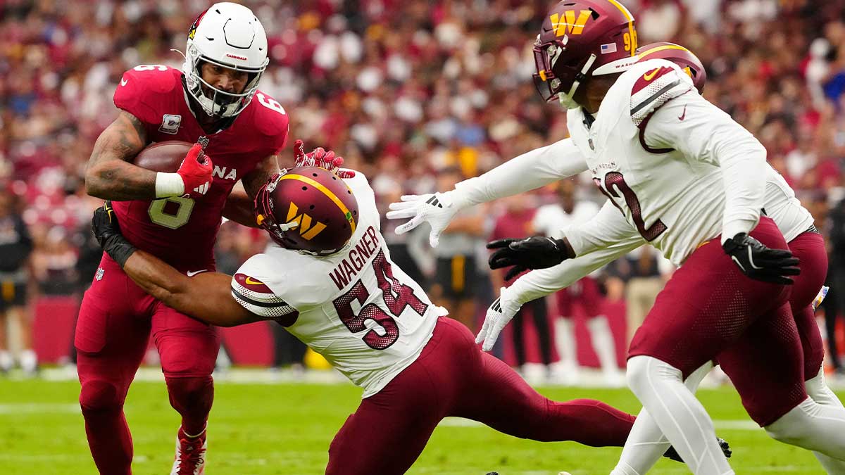 Commanders linebacker Bobby Wagner (54) tackles Cardinals running back James Conner (6) during a game at State Farm Stadium in Glendale on Sept. 29, 2024.