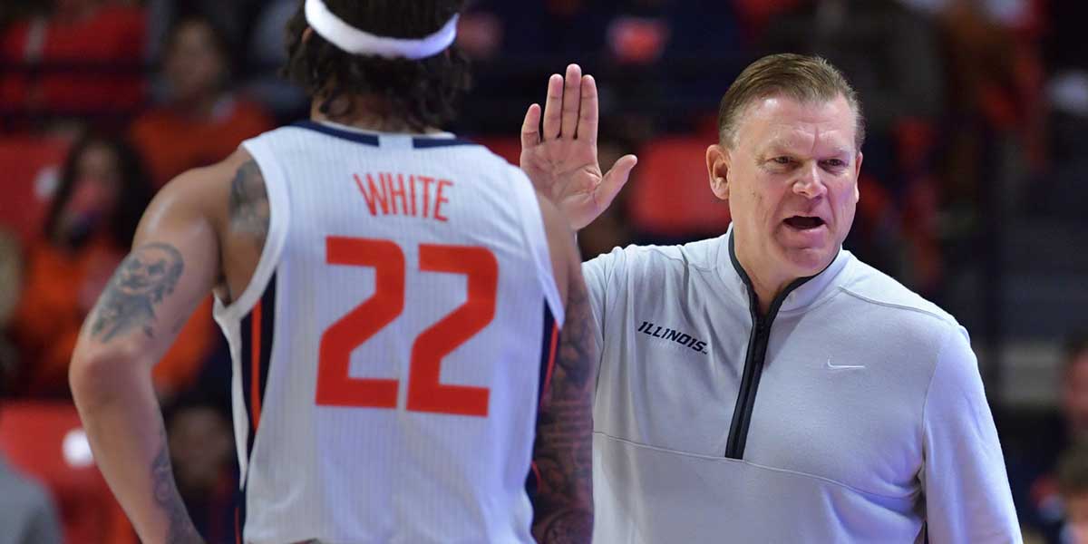 Illinois Fighting Illini head coach Brad Underwood gives a hand to guard Tre White (22) during the second half against the Maryland-Eastern Shore Hawks at State Farm Center.