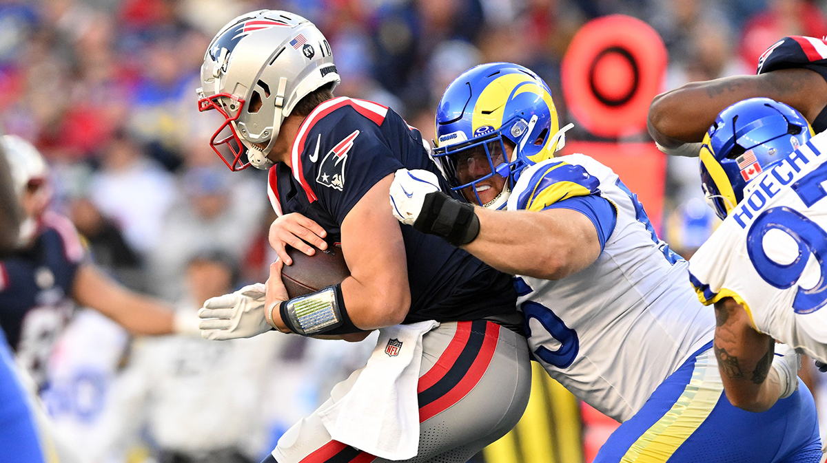 Los Angeles Rams defensive tackle Braden Fiske (55) tackles New England Patriots quarterback Drake Maye (10) during the second half at Gillette Stadium.