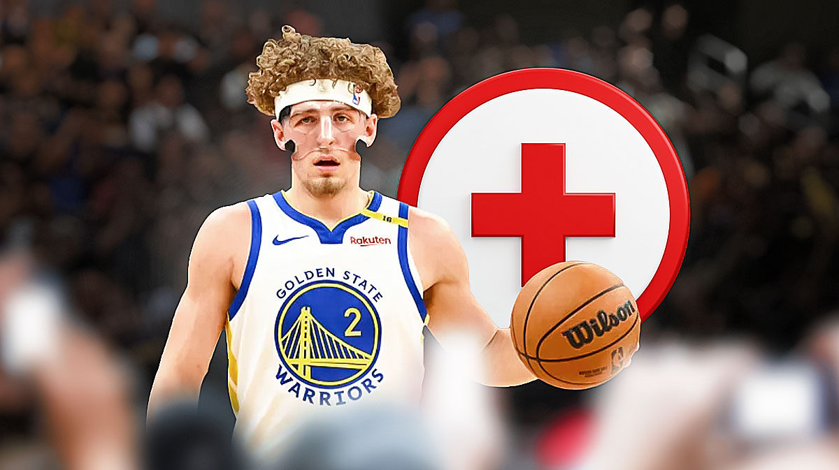 Warriors guard Brandin Podziemski wearing a mask with the Chase Center behind him and a red/white medical cross in the open space next to him