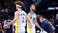Golden State Warriors guard Stephen Curry (30) reacts with Golden State Warriors guard Brandin Podziemski (2) after losing his shoe during the first half against the Dallas Mavericks at American Airlines Center.