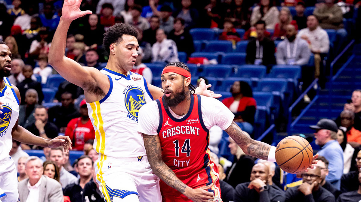 New Orleans Pelicans forward Brandon Ingram (14) dribbles against Golden State Warriors forward Trayce Jackson-Davis (32) during first half at Smoothie King Center.