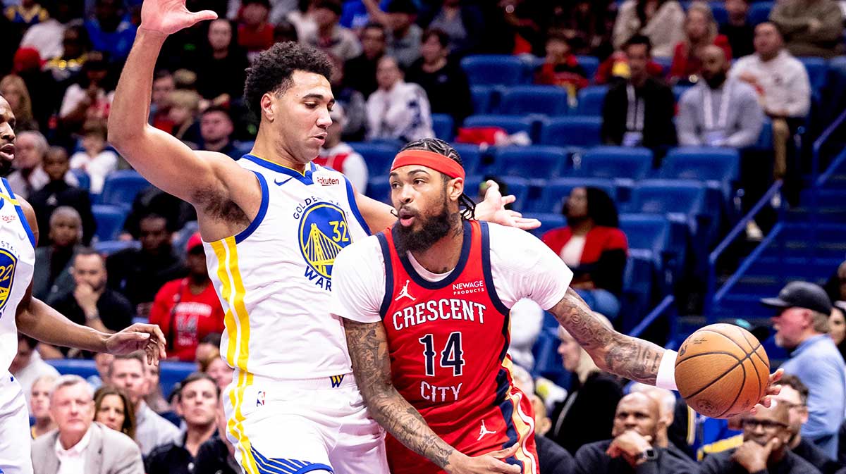 New Orleans Pelicans forward Brandon Ingram (14) dribbles against Golden State Warriors forward Trayce Jackson-Davis (32) in the first half at the Smoothie King Center.