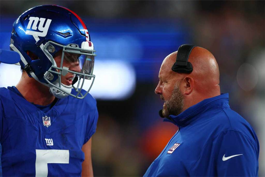 New York Giants head coach Brian Daboll speaks with quarterback Tommy DeVito (5) during the second half of their game against the New York Jets at MetLife Stadium. 