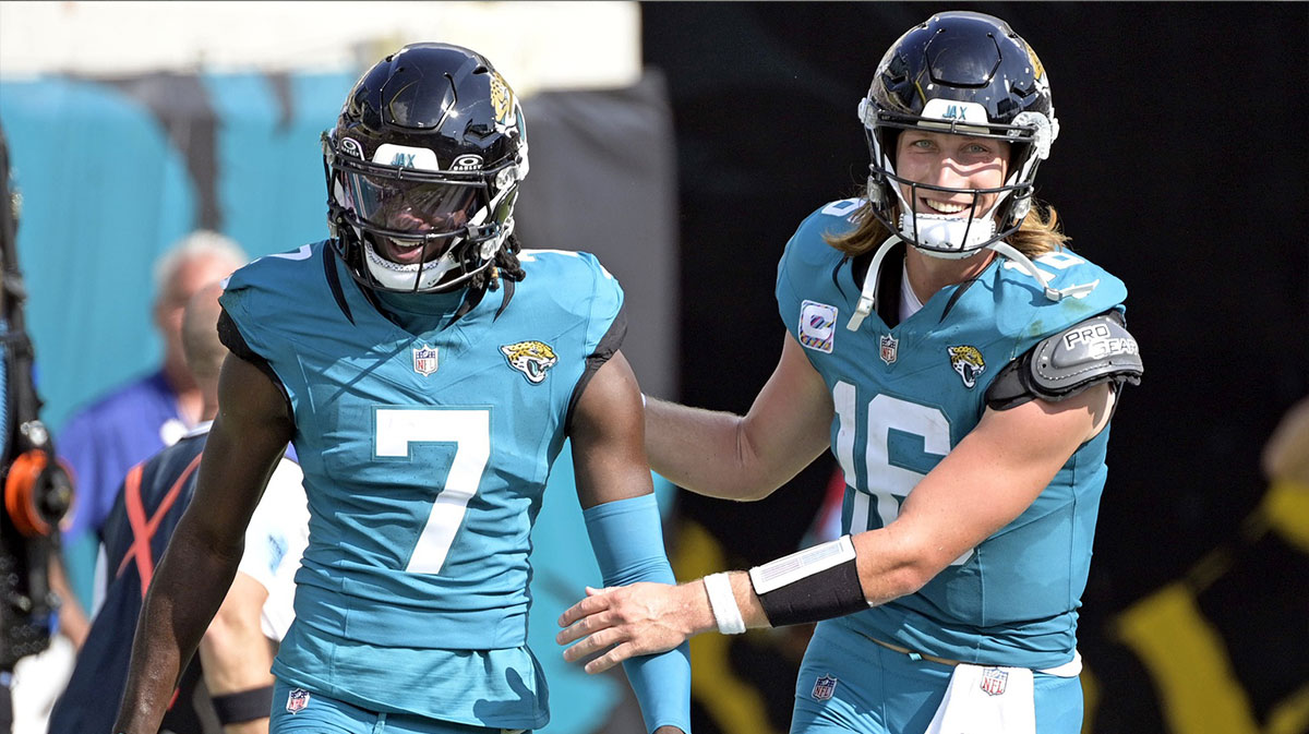 Jacksonville Jaguars quarterback Trevor Lawrence (16) celebrates a touchdown with wide receiver Brian Thomas Jr. (7) during the second half against the Green Bay Packers at EverBank Stadium.