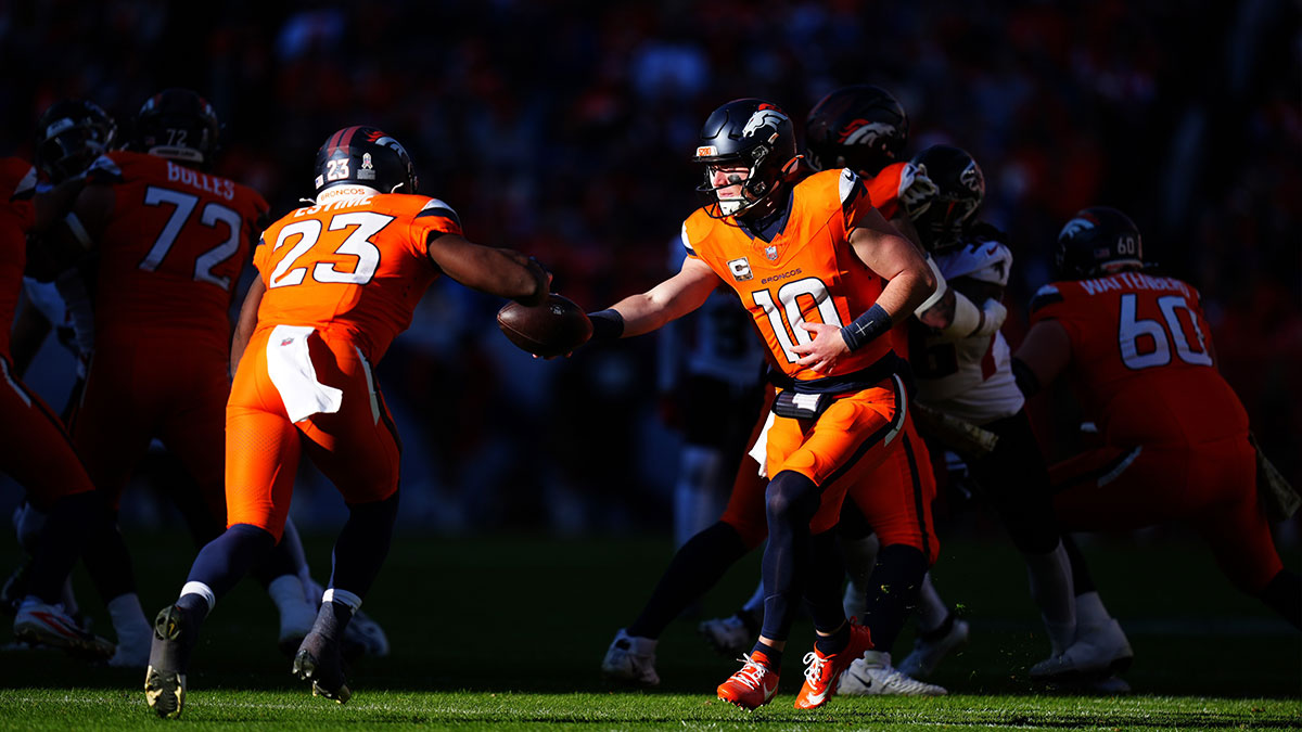 Denver Broncos quarterback Bo Nix (10) hands off to running back Audric Estime (23) in the first quarter against the Atlanta Falcons at Empower Field at Mile High