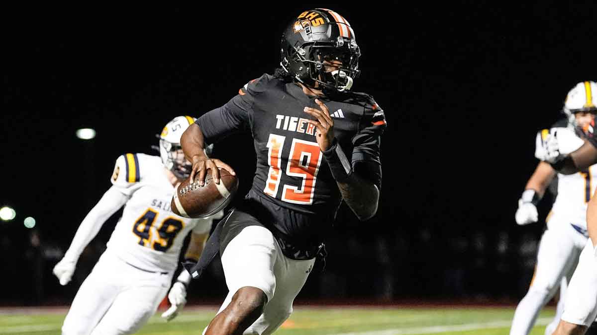 Belleville quarterback Bryce Underwood keeps the ball and runs against Saline during the second half of district final at Belleville High School in Belleville on Friday, Nov. 8, 2024.