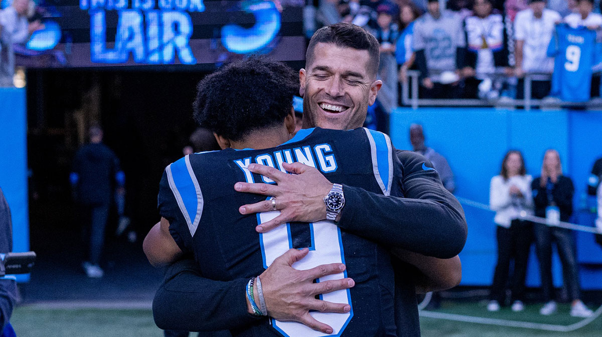 Carolina Panthers head coach Dave Canales hugs quarterback Bryce Young (9) after getting the win against the New Orleans Saints at Bank of America Stadium.