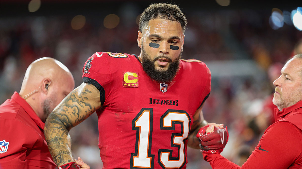 Tampa Bay Buccaneers wide receiver Mike Evans (13) is helped off the field by trainers against the Baltimore Ravens in the second quarter at Raymond James Stadium.