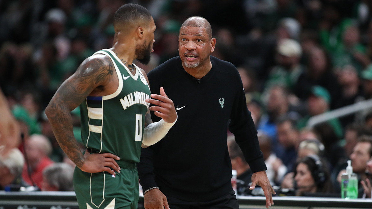 Milwaukee Bucks head coach Doc Rivers talks to Milwaukee Bucks guard Damian Lillard (0) during the first half against the Boston Celtics at TD Garden. 