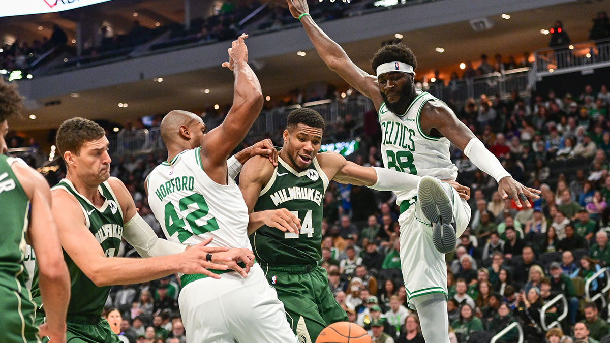 Milwaukee Bucks forward Giannis Antetokounmpo (34) reaches for a rebound between Boston Celtics center Al Horford (42) and center Neemias Queta (88) in the second quarter at Fiserv Forum