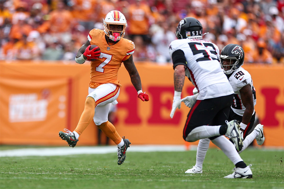 October 27, 2024; Tampa, Florida, USA; Tampa Bay Buccaneers running back Bucky Irving (7) runs with the ball against the Atlanta Falcons during the third quarter at Raymond James Stadium. 