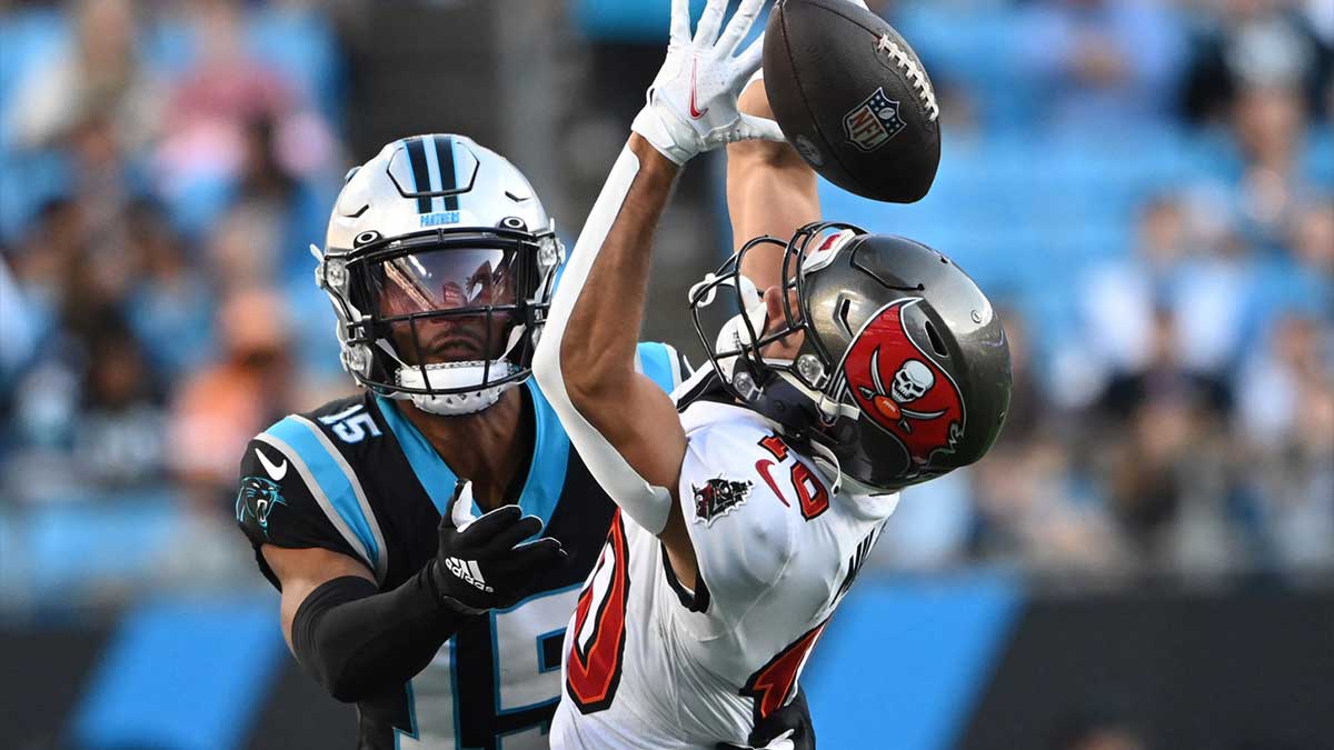 Dec 26, 2021; Charlotte, North Carolina, USA; Tampa Bay Buccaneers wide receiver Scott Miller (10) tries to catch the ball as Carolina Panthers cornerback C.J. Henderson (15) defends in the fourth quarter at Bank of America Stadium. 