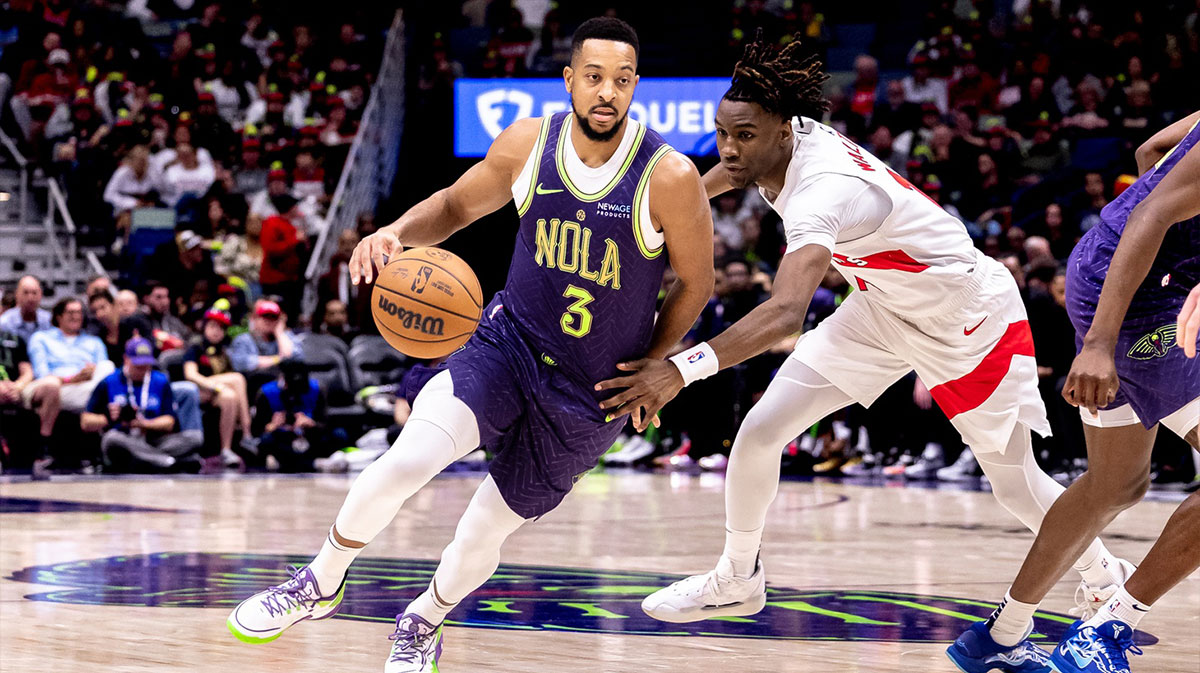 New Orleans Pelicans guard CJ McCollum (3) dribbles agains Toronto Raptors guard Ja'Kobe Walter (14) during the first half at Smoothie King Center.