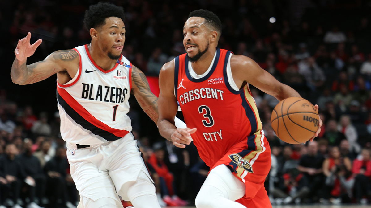 New Orleans Pelicans guard CJ McCollum (3) drives on Portland Trail Blazers guard Anfernee Simons (1) in the first half at Moda Center.